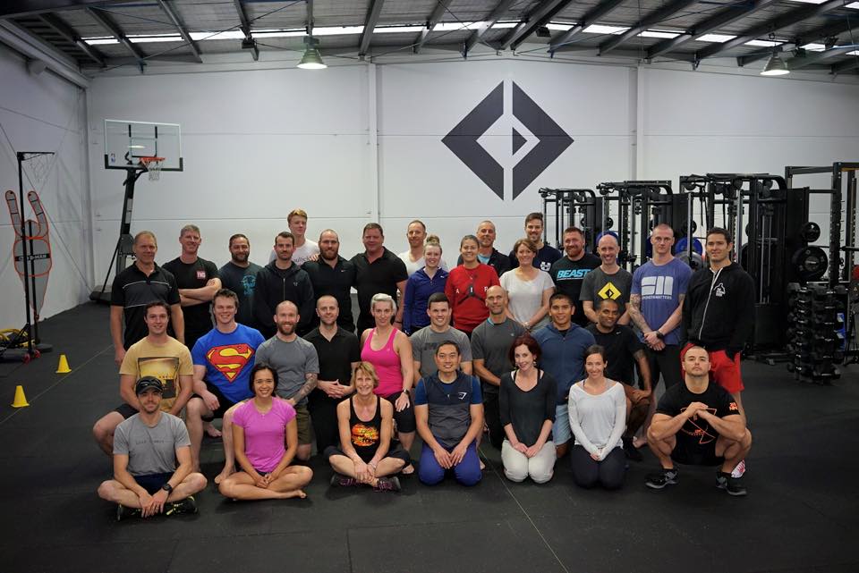 Group photo of athletes and coaches at a Dan John seminar